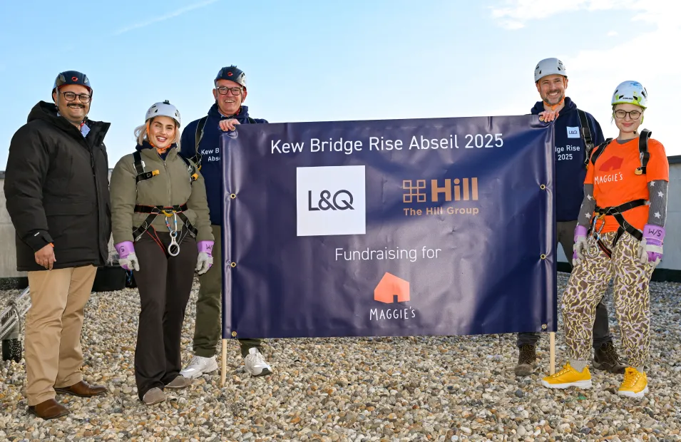 Livi, Hill and Maggies team photo with banner for abseil