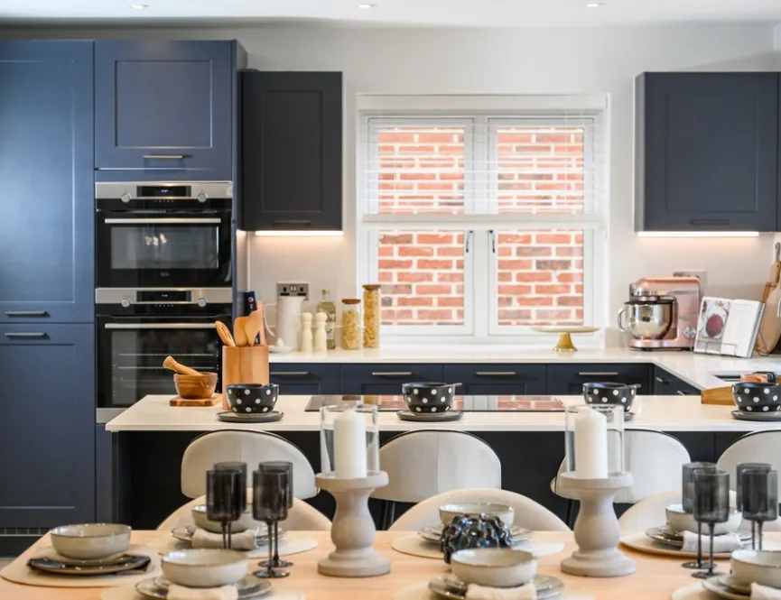 Modern kitchen with dark cupboard doors and a set dining table