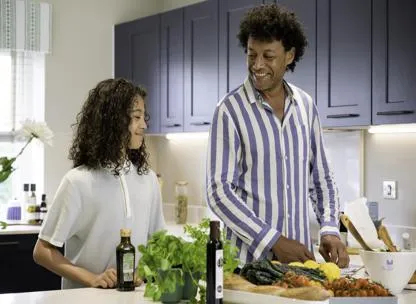Dad and child cooking in the kitchen at a home in Eden Green