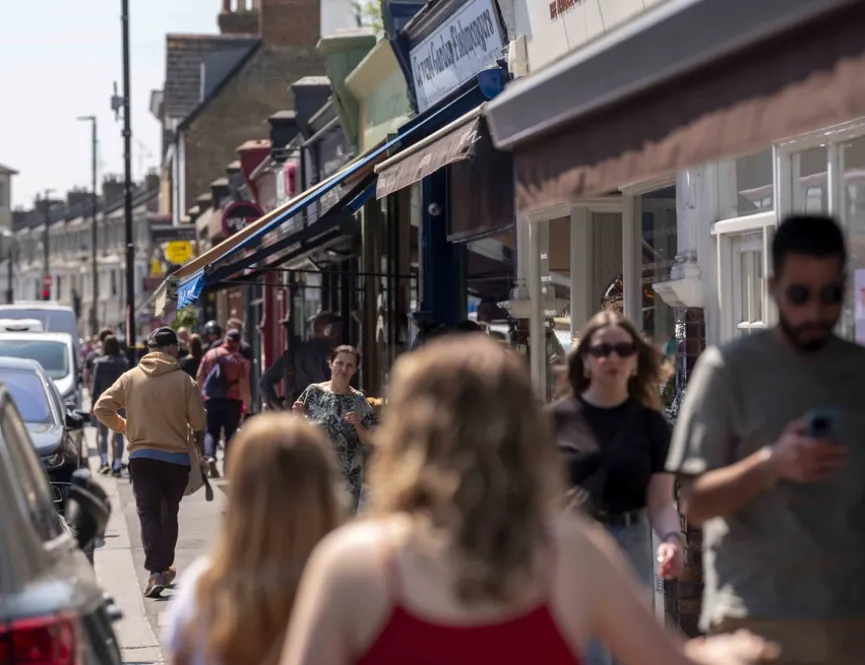 Busy high street in Brentford with people walking past shops