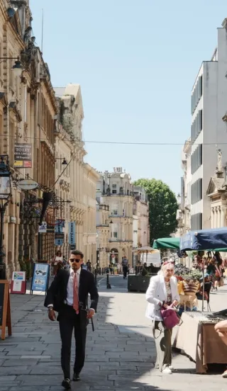 View of a market in the centre of Bristol with people walking by