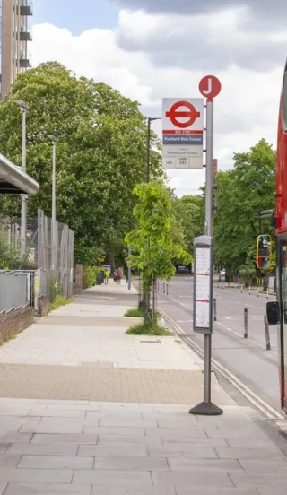 Red Arriva bus parked at bus stop in London