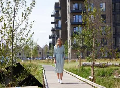 Young woman walking through the grounds at Timber Works home development